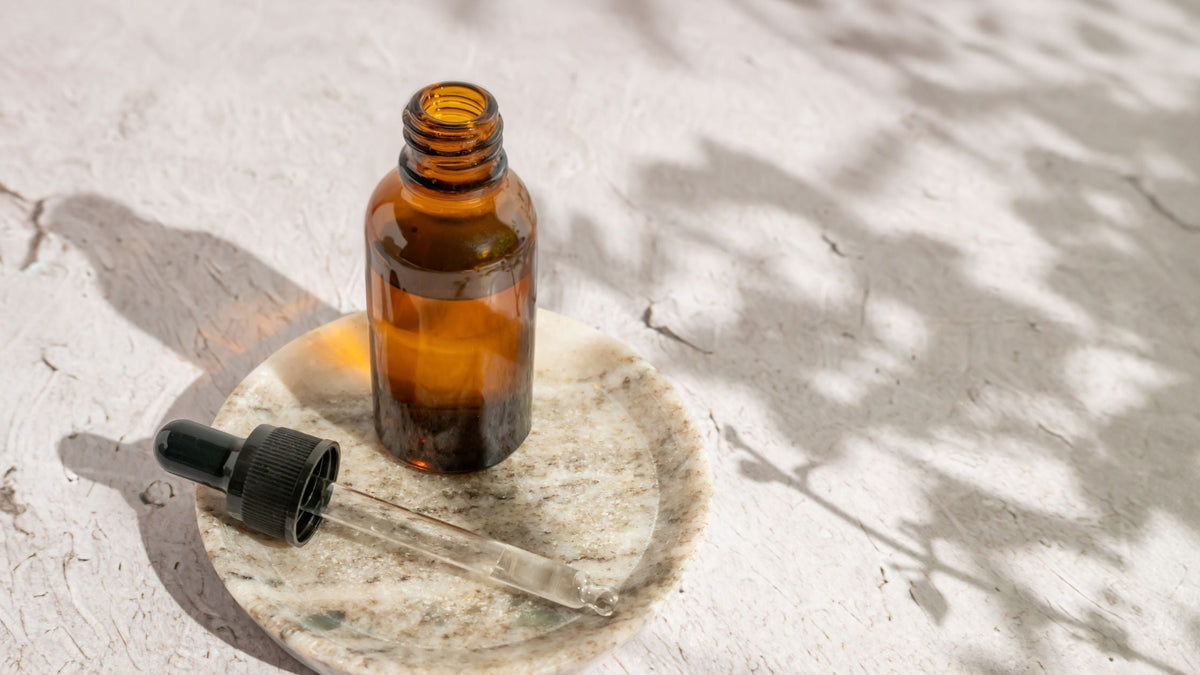 Dropper and bottle with essential oil, face serum or retinol or medicinal liquid