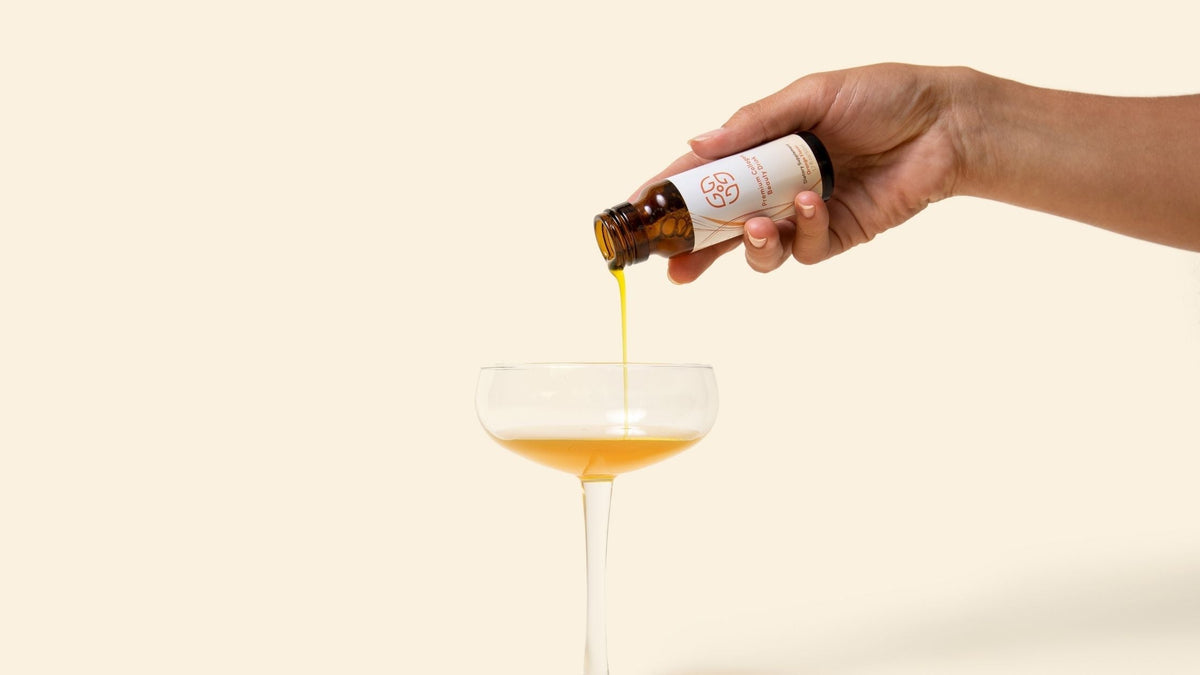 Hand pouring premium collagen beauty drink into glass