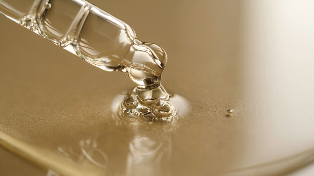 Pipettes with Oil or Serum on a Golden Background