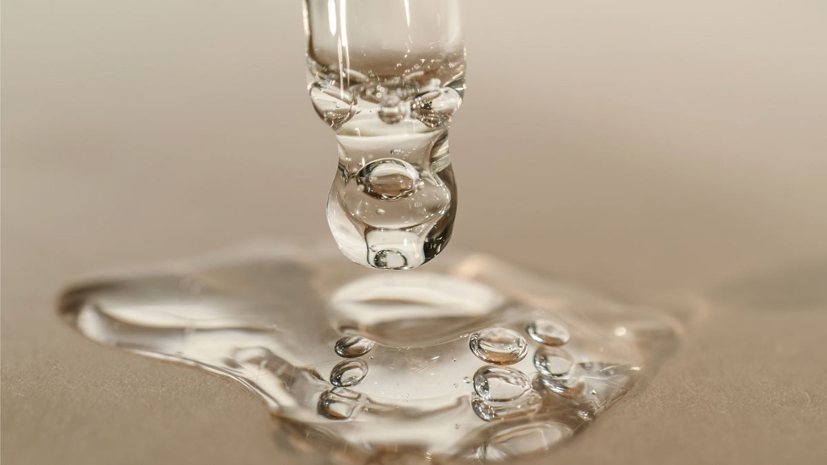 The Texture of Serum or Oil with a Pipette on a Beige Background