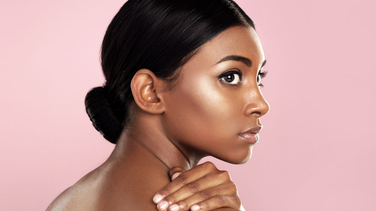Woman with Glowing Hydrated Skin on Pink Background