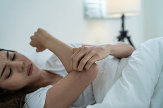 Asian young woman scratching hand while sleeping